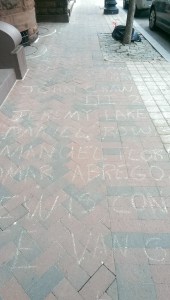 The names of people killed by the police in the United States, written in chalk, lined North Charles Street over several blocks in Baltimore. 